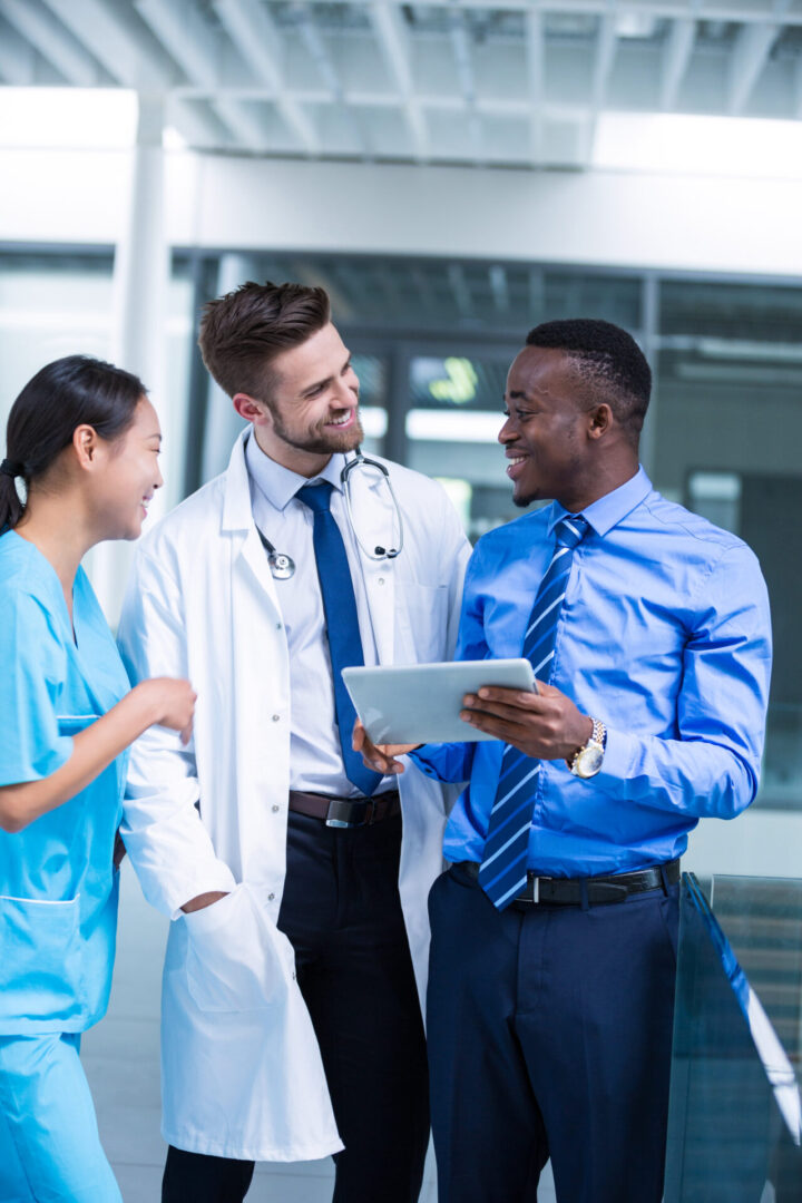 Nurse and doctor having a discussion with businessman in hospital